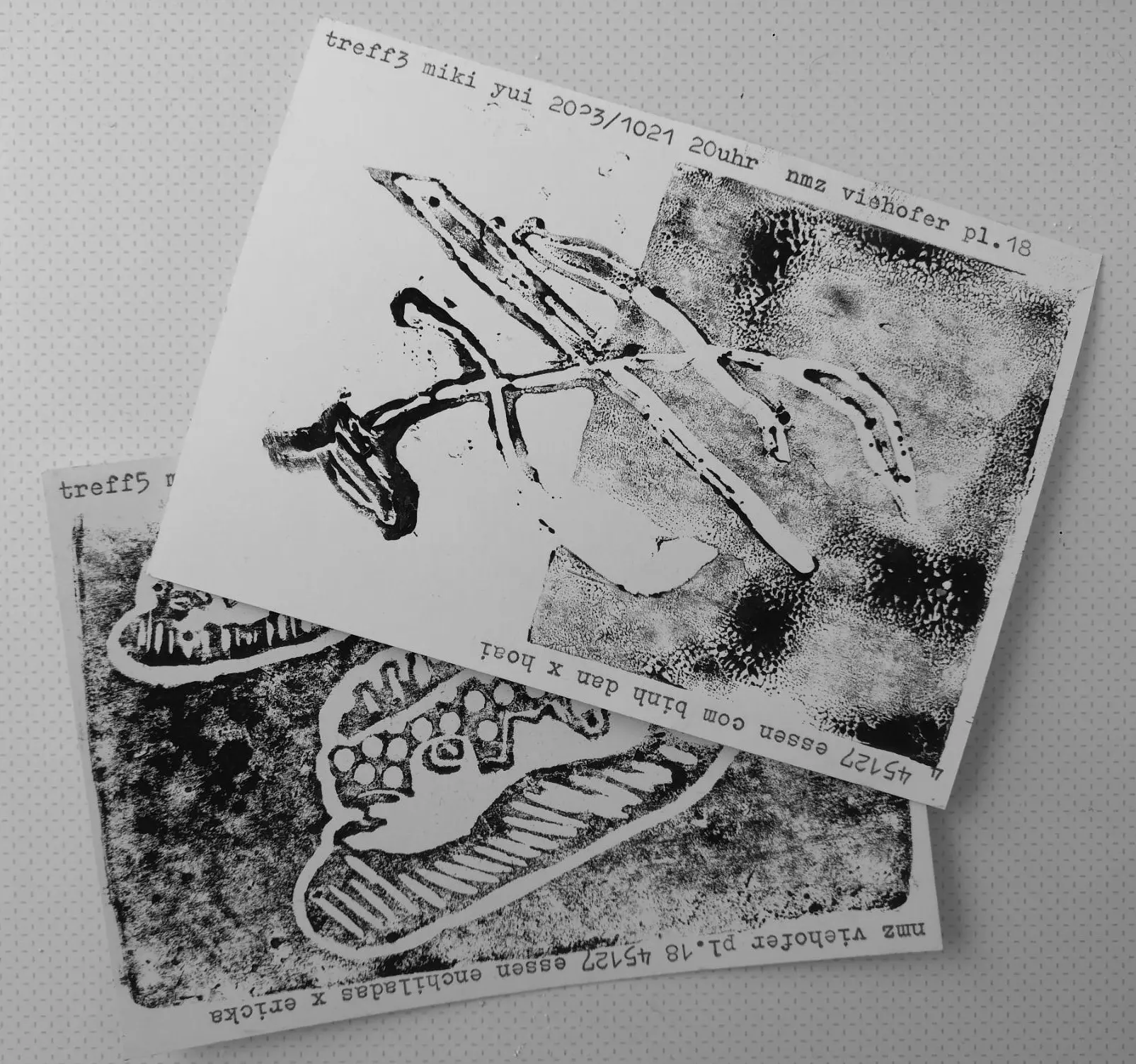 two postcards with a black-and-white print depicting vegetables
